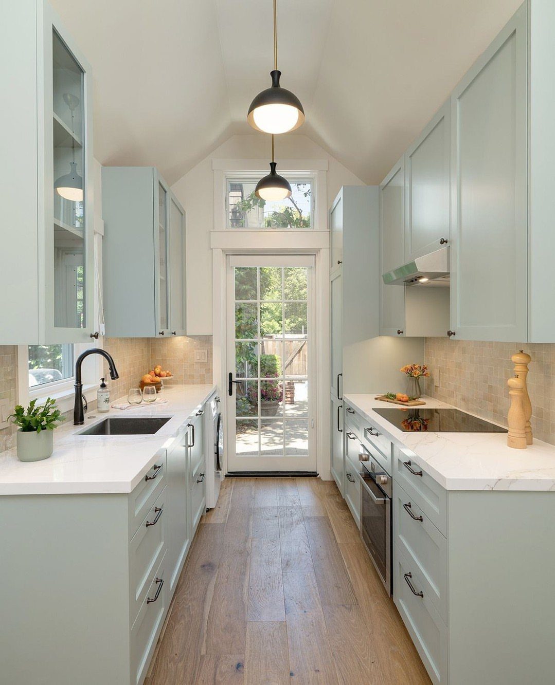 22 Apt Kitchen Ideas to Maximize Style and Function 4 Galley kitchen with light blue cabinets, white countertops, and light wood flooring.