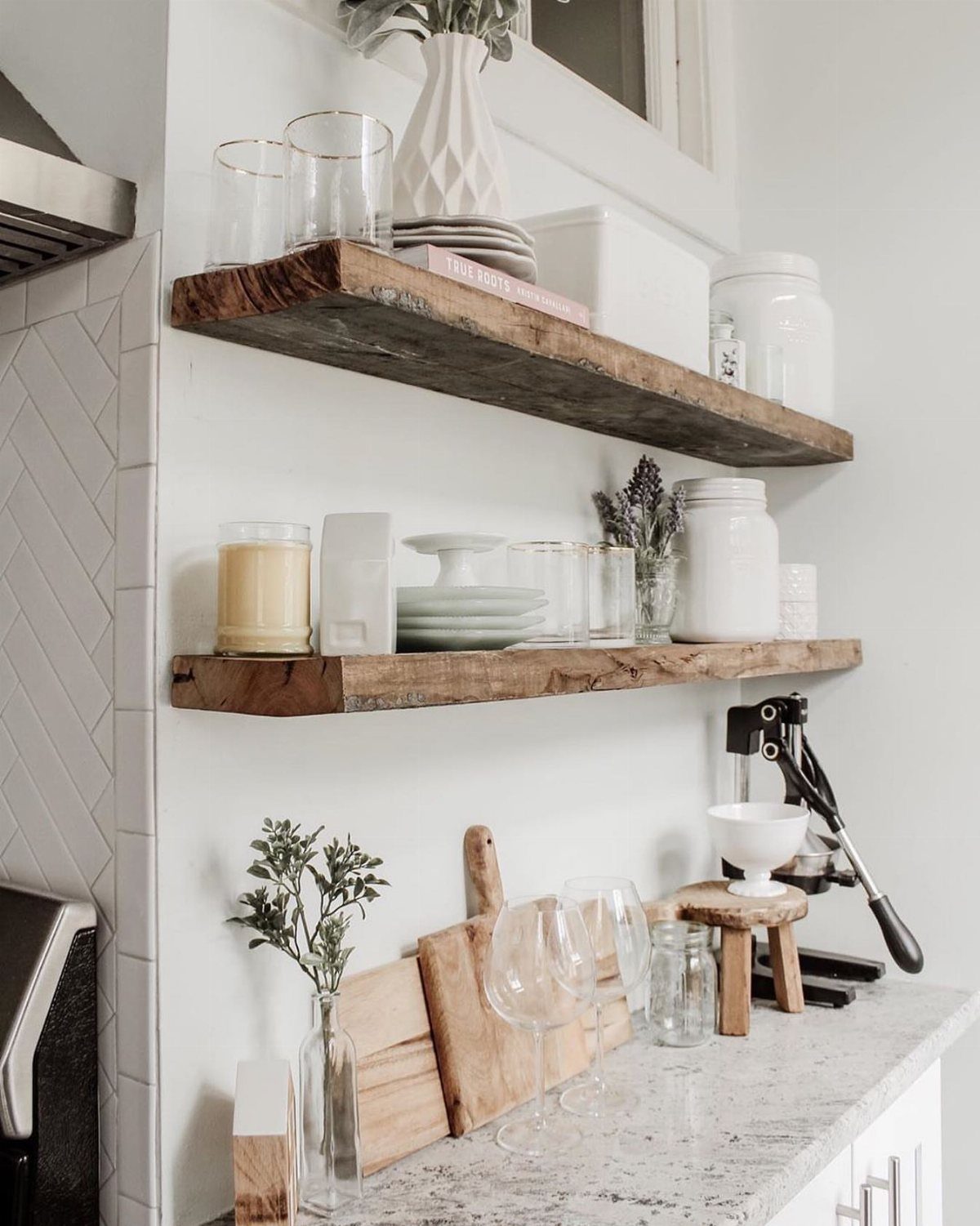 22 Apt Kitchen Ideas to Maximize Style and Function 19 Rustic reclaimed wood floating shelves holding white ceramics and glassware in a bright kitchen