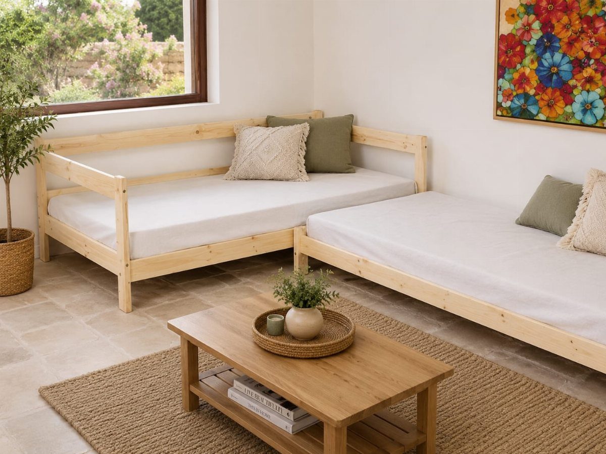L-shaped wooden sectional sofa with white cushions in a bright, rustic living room