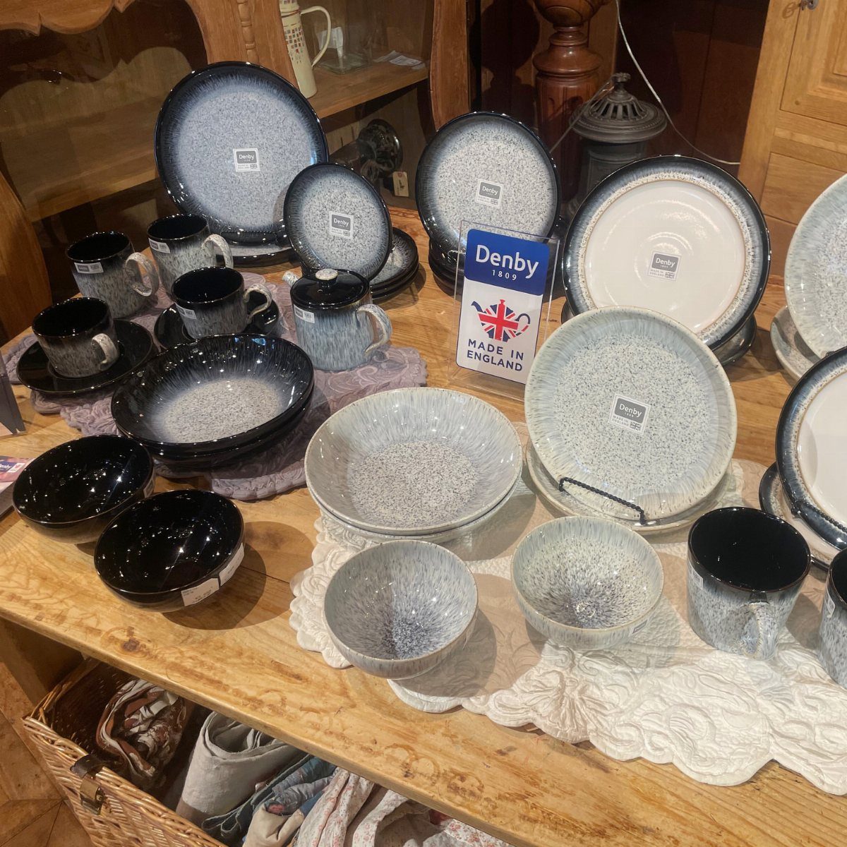 Denby Dinnerware Sets in 5 Classic Styles 4 Denby dinnerware sets featuring blue and grey speckled plates, bowls, and mugs on wood.