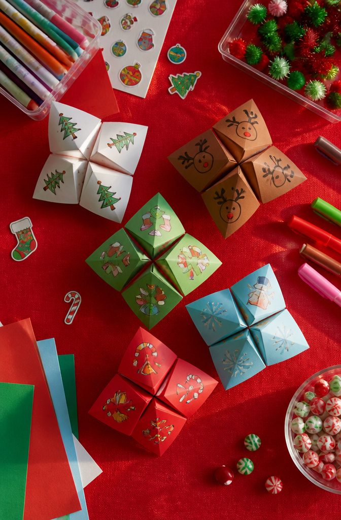 Folded paper fortune tellers with Christmas motifs.