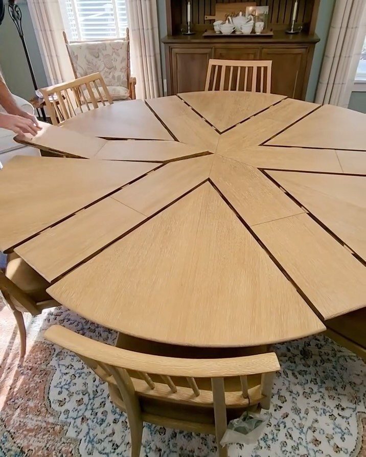 Extendable Kitchen Table Designs: 16 Ideas with Photos 13 Round wooden table with wedge-shaped leaf inserts being added to expand the surface.