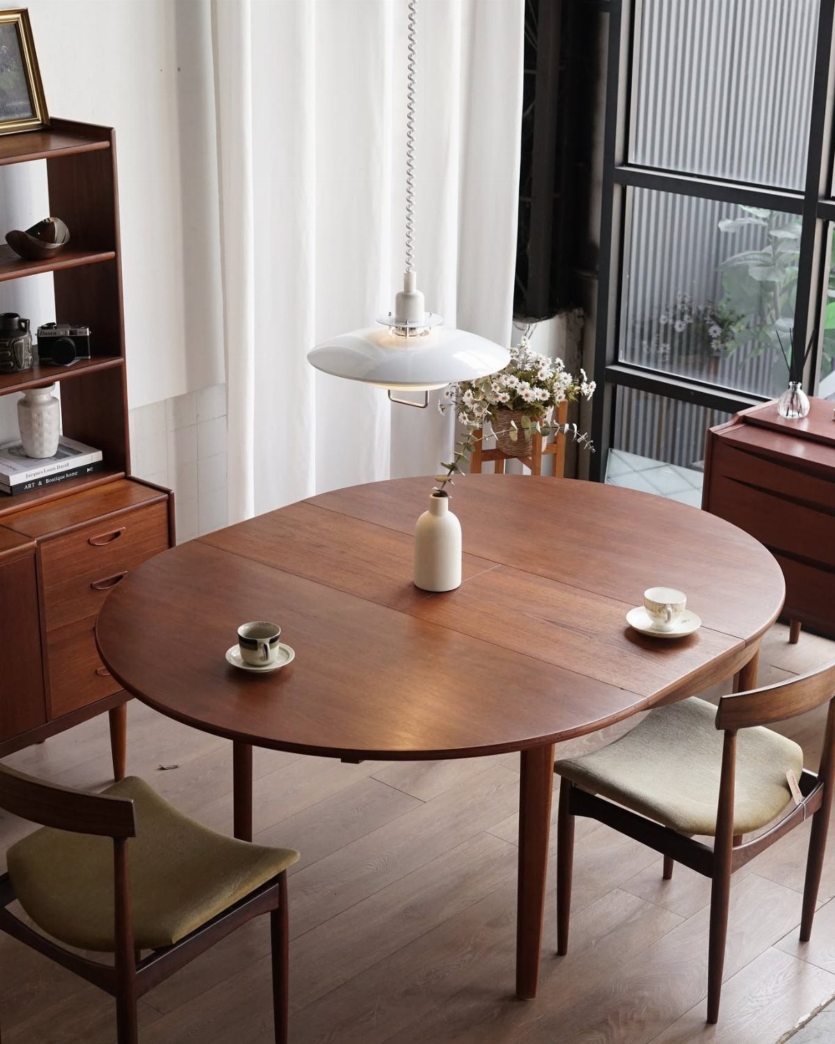 Extendable Kitchen Table Designs: 16 Ideas with Photos 16 Round brown wooden extendable kitchen table with chairs in a bright, modern room.