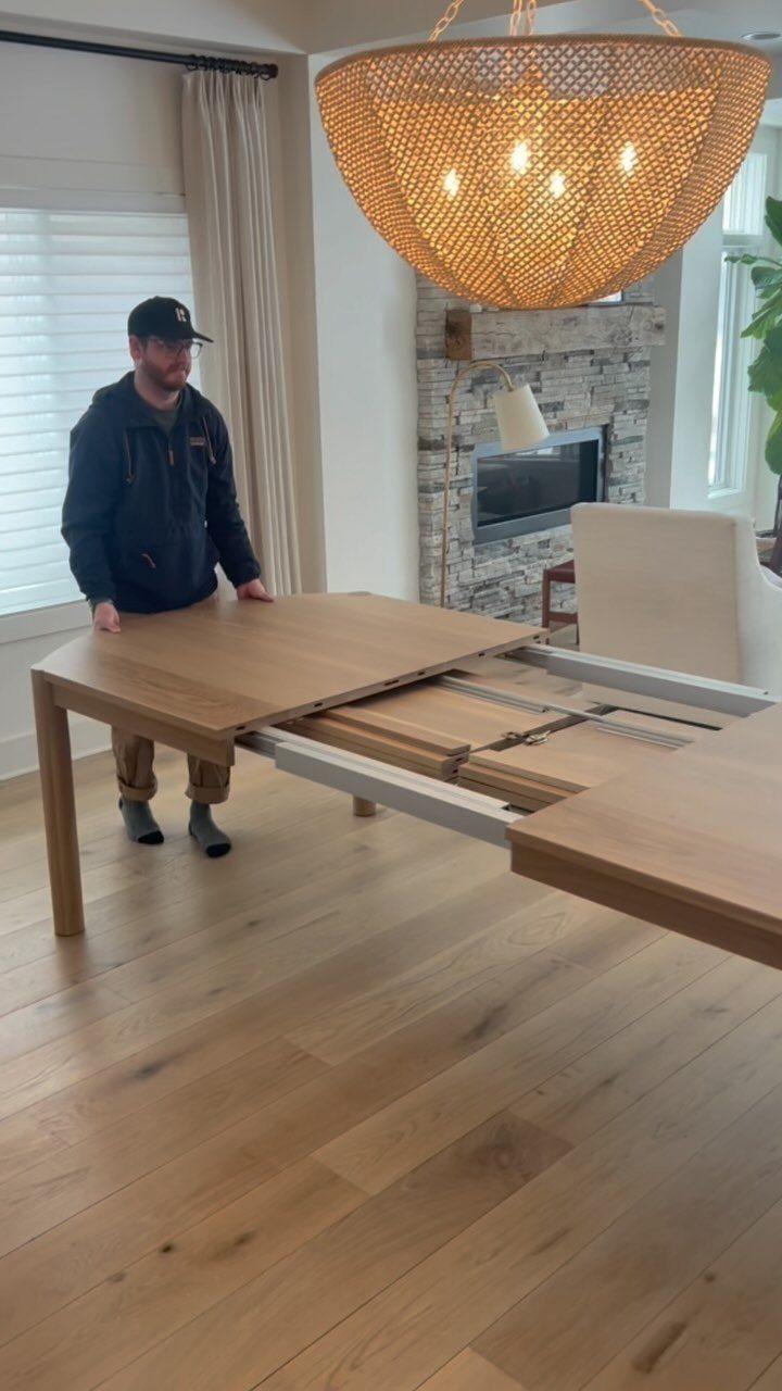 Extendable Kitchen Table Designs: 16 Ideas with Photos 14 Light wood extendable table partially opened showing internal sliding mechanism in a bright room.