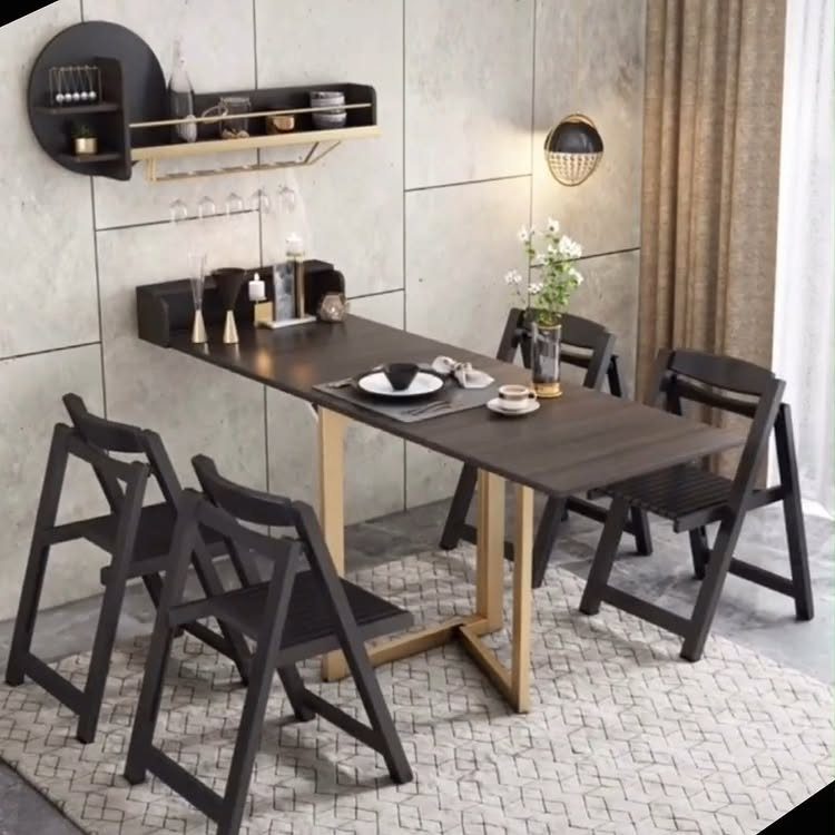 Dark wood dining table with black folding chairs on a patterned rug.