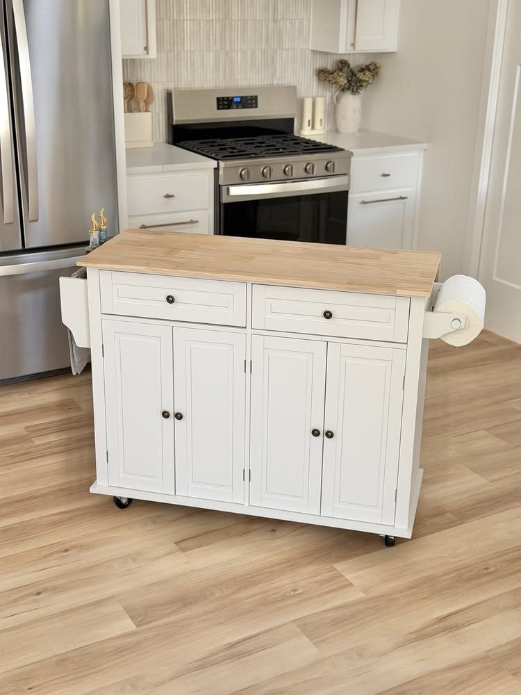White rolling kitchen island with light wood top on a light wood floor.