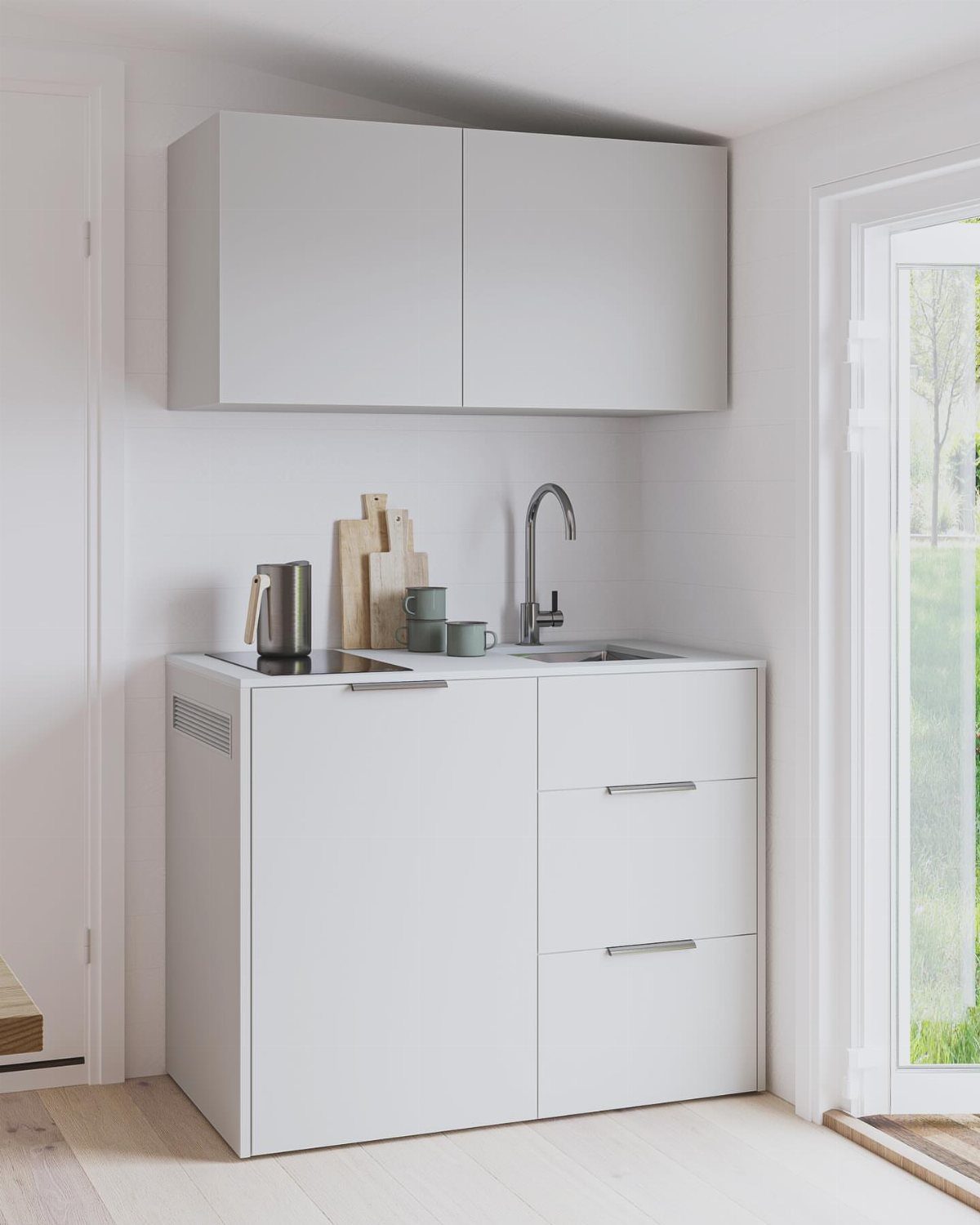 Small white kitchenette with white cabinets, a compact sink, and light wood flooring.