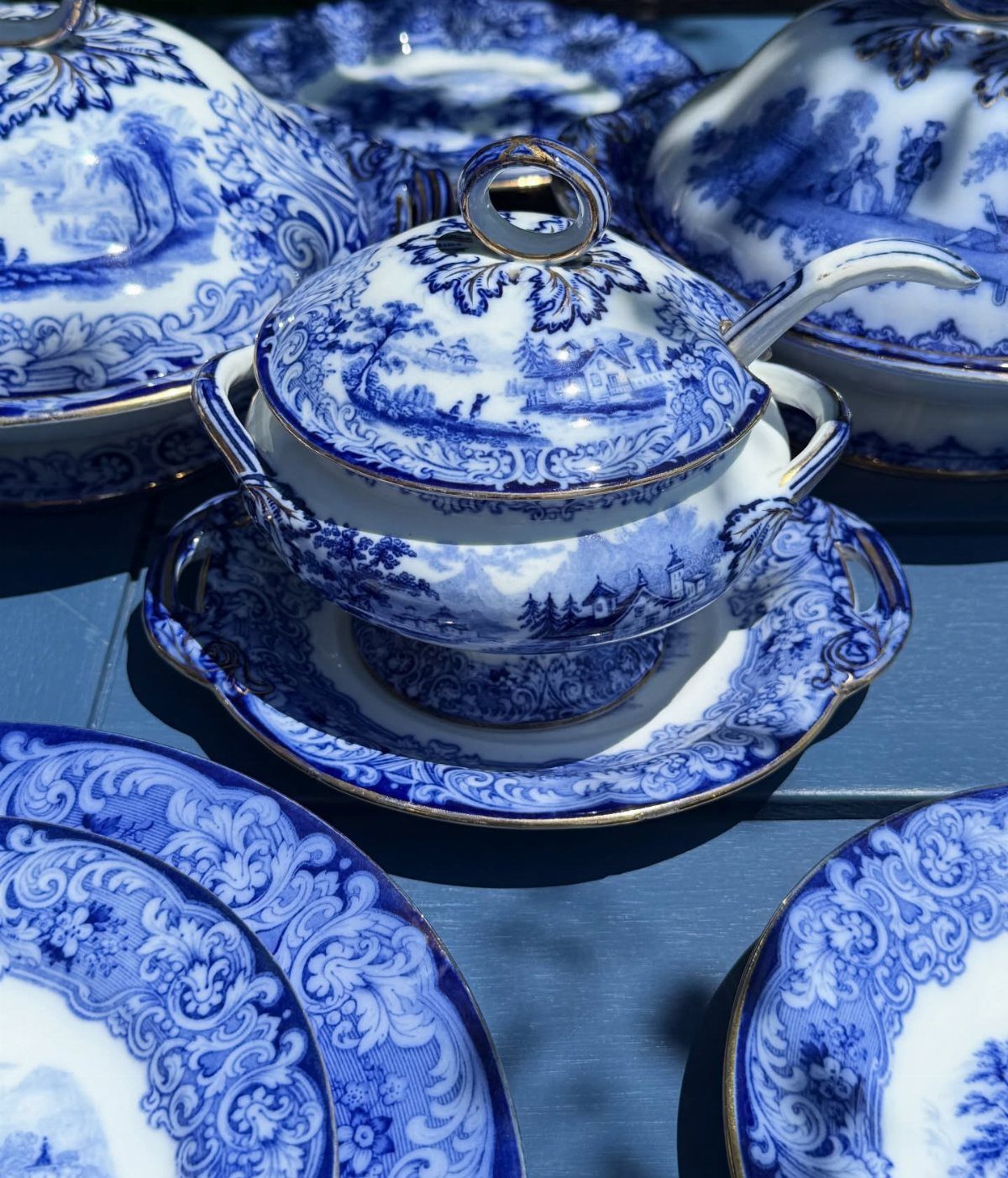 Fancy Dinnerware Set Ideas for 2026 Tables (28 Styles) 15 Blue and white porcelain dinnerware set with gold rims and landscape patterns.
