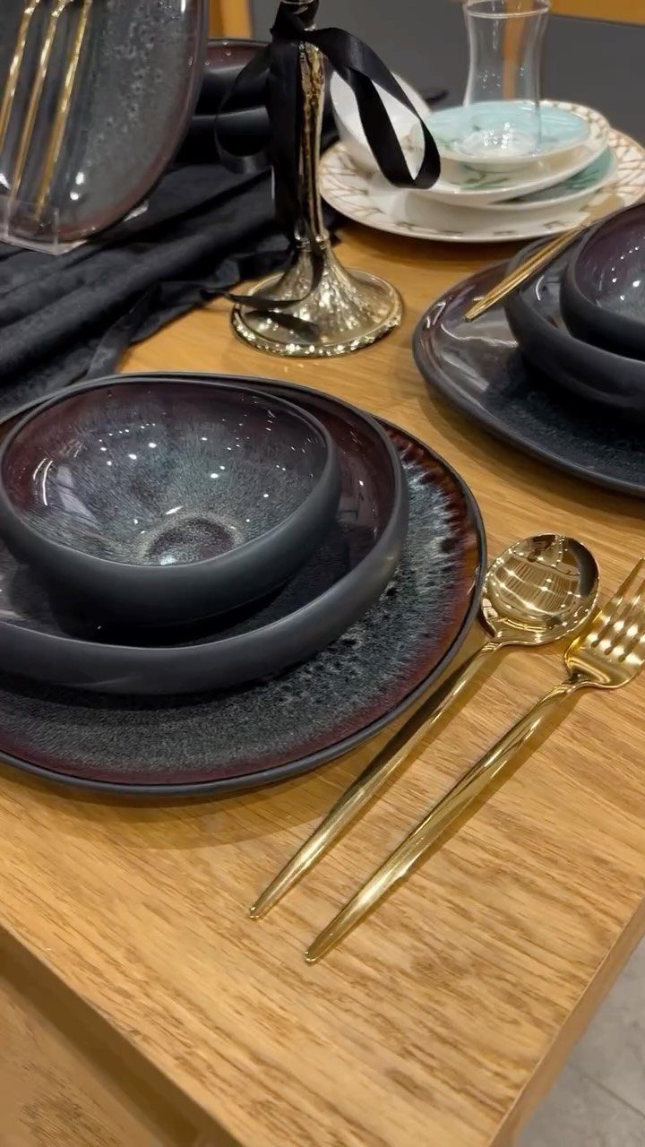 Fancy Dinnerware Set Ideas for 2026 Tables (28 Styles) 21 Dark purple ceramic dinnerware set with gold cutlery on a light wooden table.