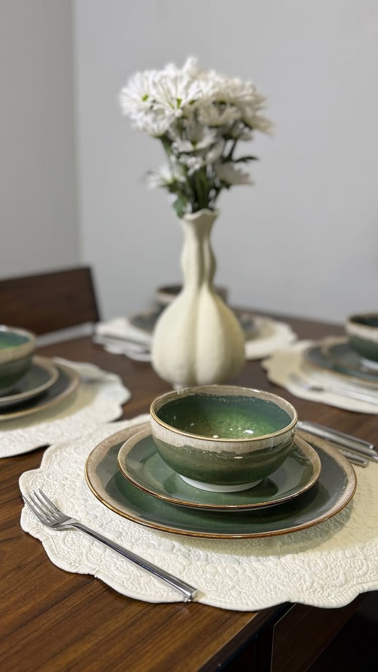 Fancy Dinnerware Set Ideas for 2026 Tables (28 Styles) 3 Green stoneware dinnerware set with a bowl and plates on a white placemat.