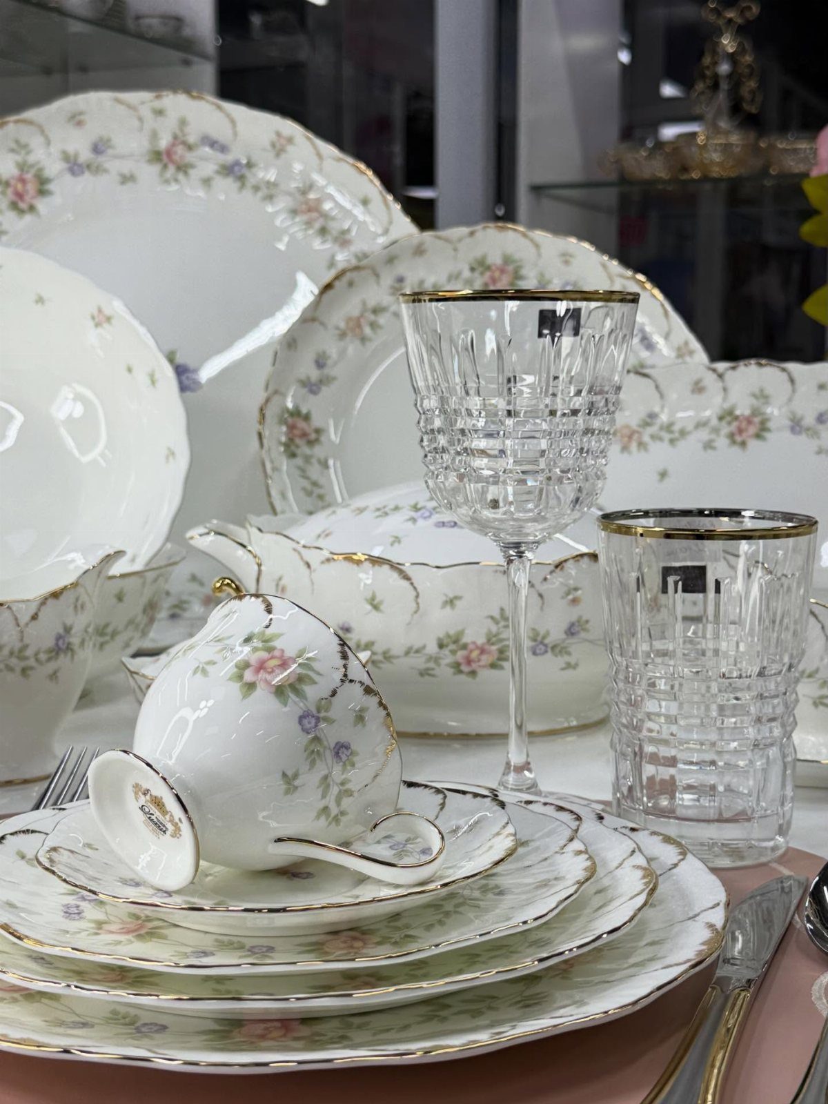 Fancy Dinnerware Set Ideas for 2026 Tables (28 Styles) 17 White porcelain dinnerware set with floral patterns and gold rims and crystal glassware.