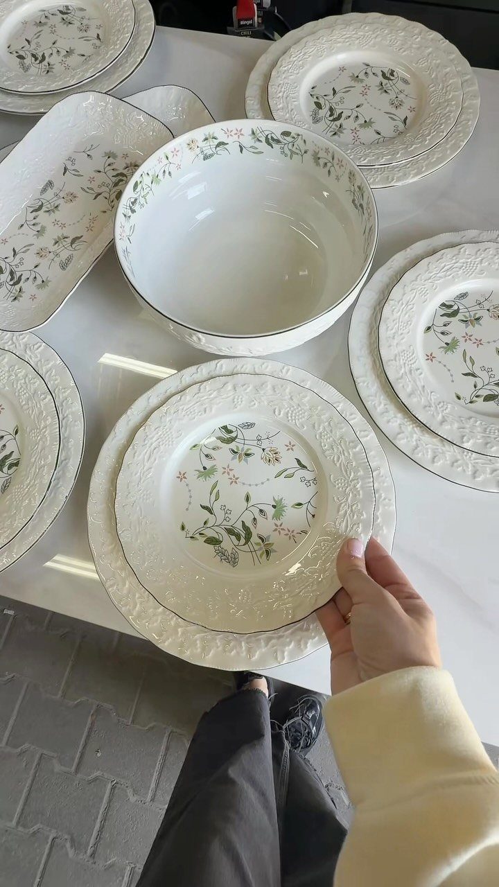 Fancy Dinnerware Set Ideas for 2026 Tables (28 Styles) 23 White ceramic dinnerware set with floral patterns and silver rims on a white table.