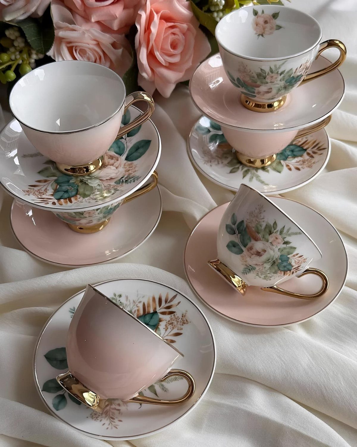 Fancy Dinnerware Set Ideas for 2026 Tables (28 Styles) 10 Pink and white floral porcelain tea cups and saucers with gold handles and roses.