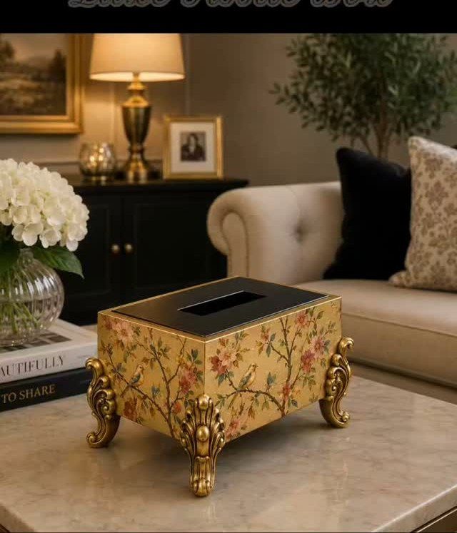 9 Gold Accent Living Room Ideas for Every Style 8 Floral gold tissue box with ornate legs on a marble table in a living room