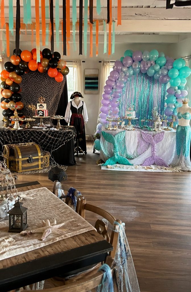 A party setup with pirate and mermaid decorations and a festive cake.