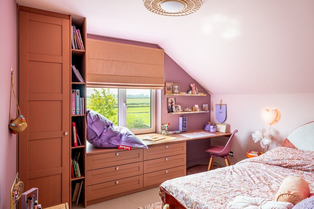 Brown modular wardrobe with integrated open shelving and built-in desk in a bedroom.