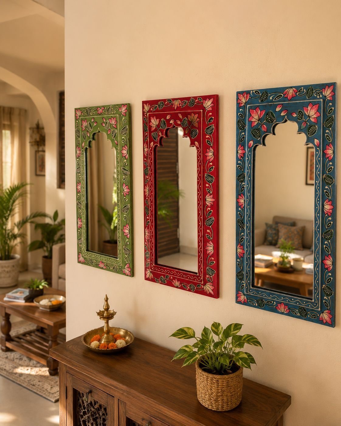 Indian Room Decor: 37 Ideas From Textiles to Wall Hangings 12 Three colorful ornate mirrors with floral frames hanging on a cream wall above furniture.