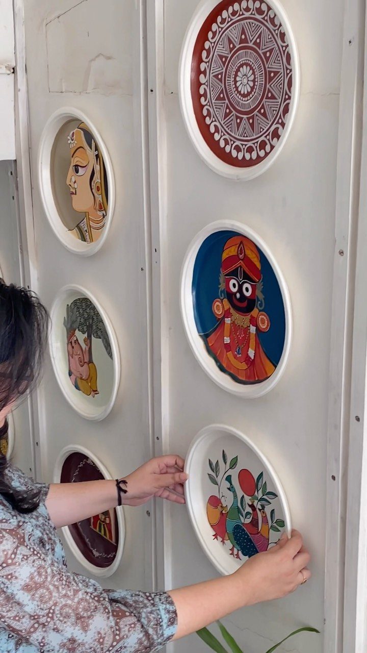 Indian Room Decor: 37 Ideas From Textiles to Wall Hangings 19 Painted decorative plates with Indian art being arranged on a white wall.