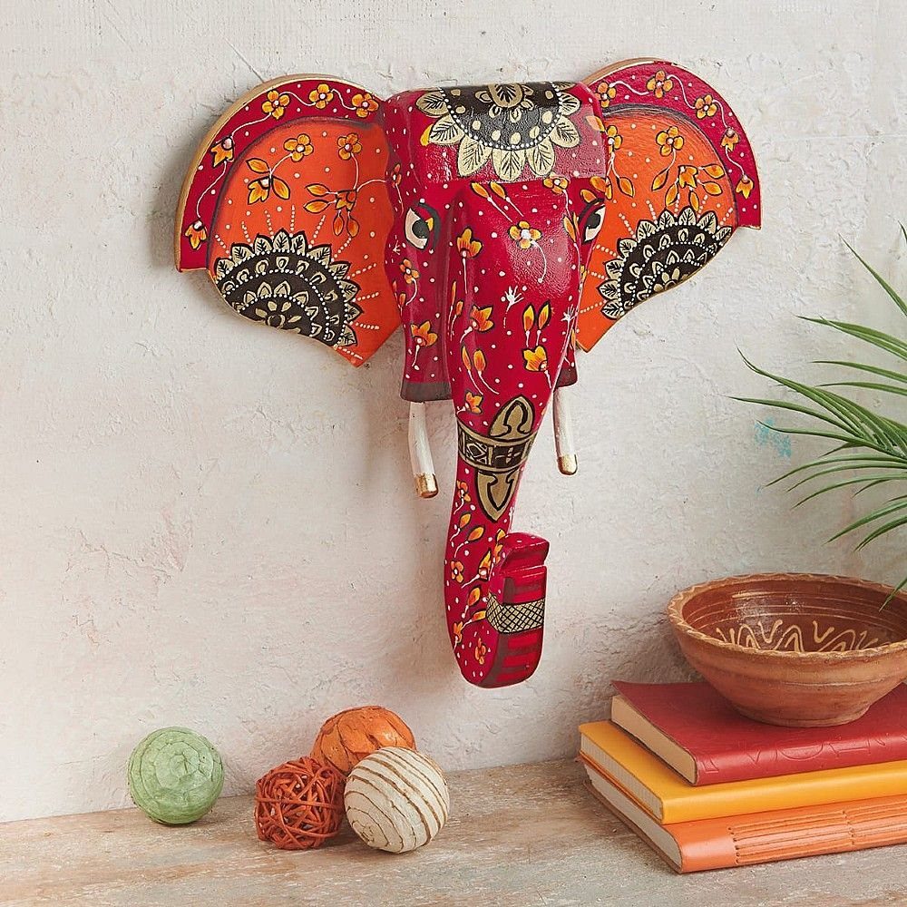 Indian Room Decor: 37 Ideas From Textiles to Wall Hangings 32 Colorful red and orange painted elephant wall hanging on a light textured wall.
