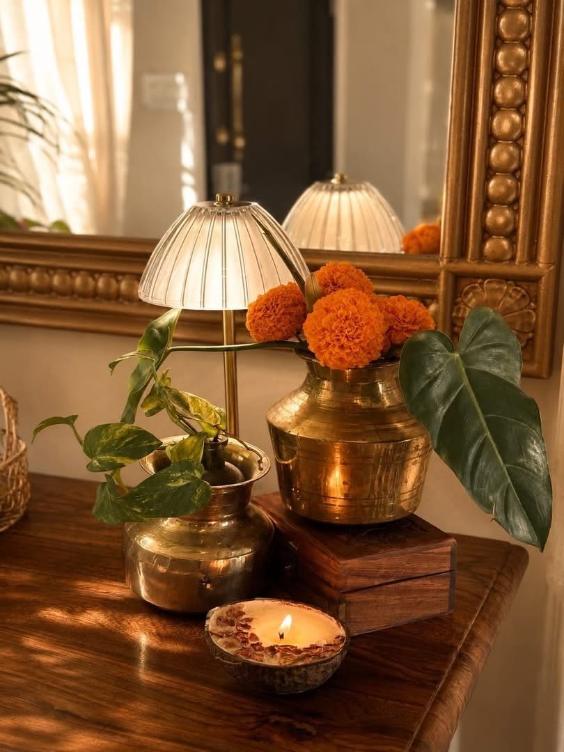 Indian Room Decor: 37 Ideas From Textiles to Wall Hangings 25 Lit diya on a wooden dresser with brass vases and orange marigolds.