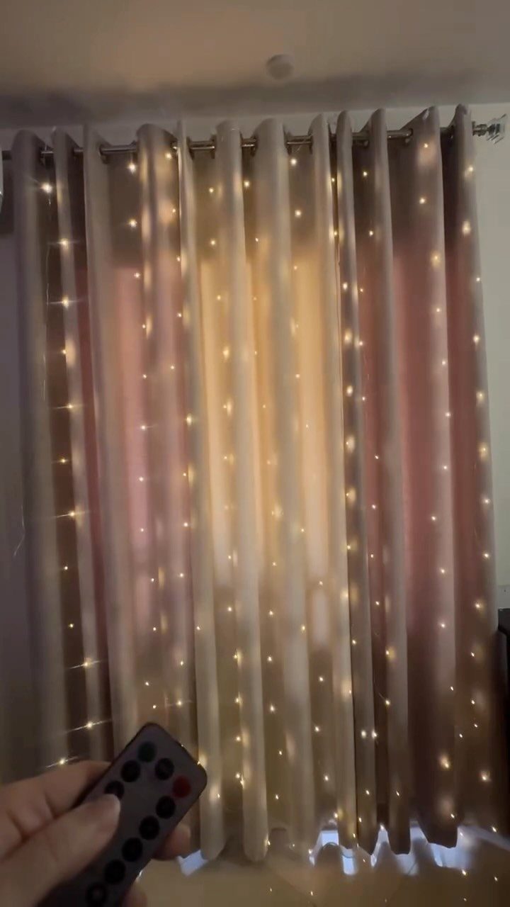 Indian Room Decor: 37 Ideas From Textiles to Wall Hangings 38 Beige curtains with glowing fairy lights and a remote control in foreground