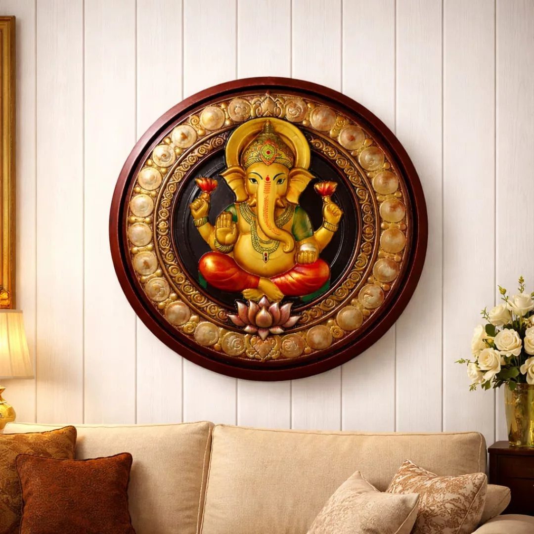 Indian Room Decor: 37 Ideas From Textiles to Wall Hangings 33 Circular Ganesh wall hanging with golden details mounted on a white paneled wall.