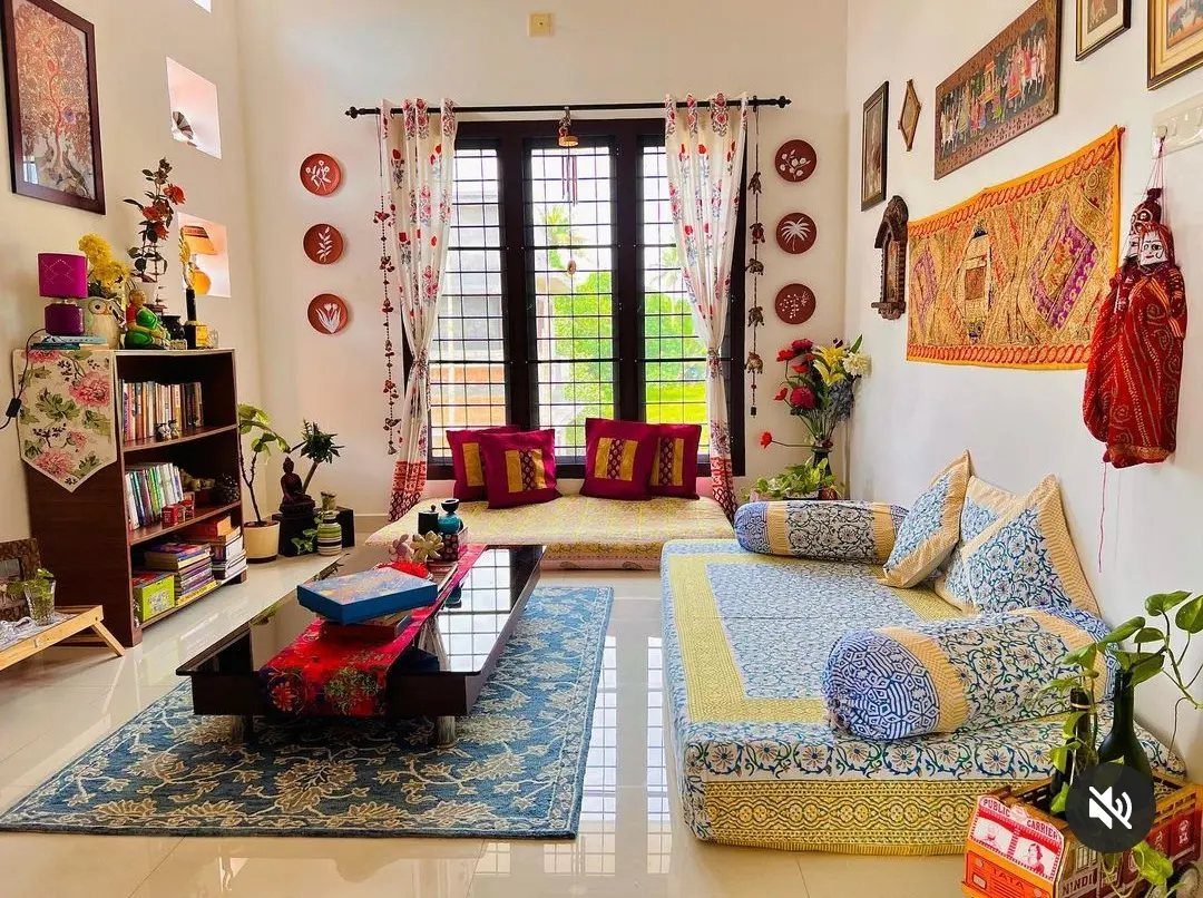 Indian Room Decor: 37 Ideas From Textiles to Wall Hangings 11 Low floor seating area with patterned cushions, blue rug, and traditional Indian decor.