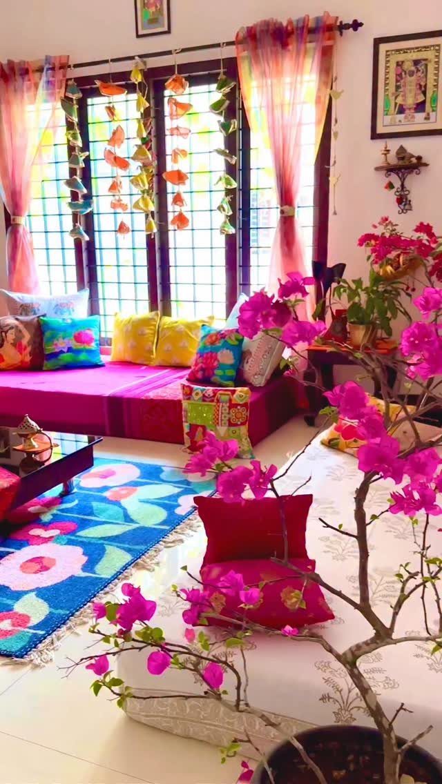 Indian Room Decor: 37 Ideas From Textiles to Wall Hangings 2 Colorful room with patterned textiles, floral rug, and bright pink cushions and bedding.
