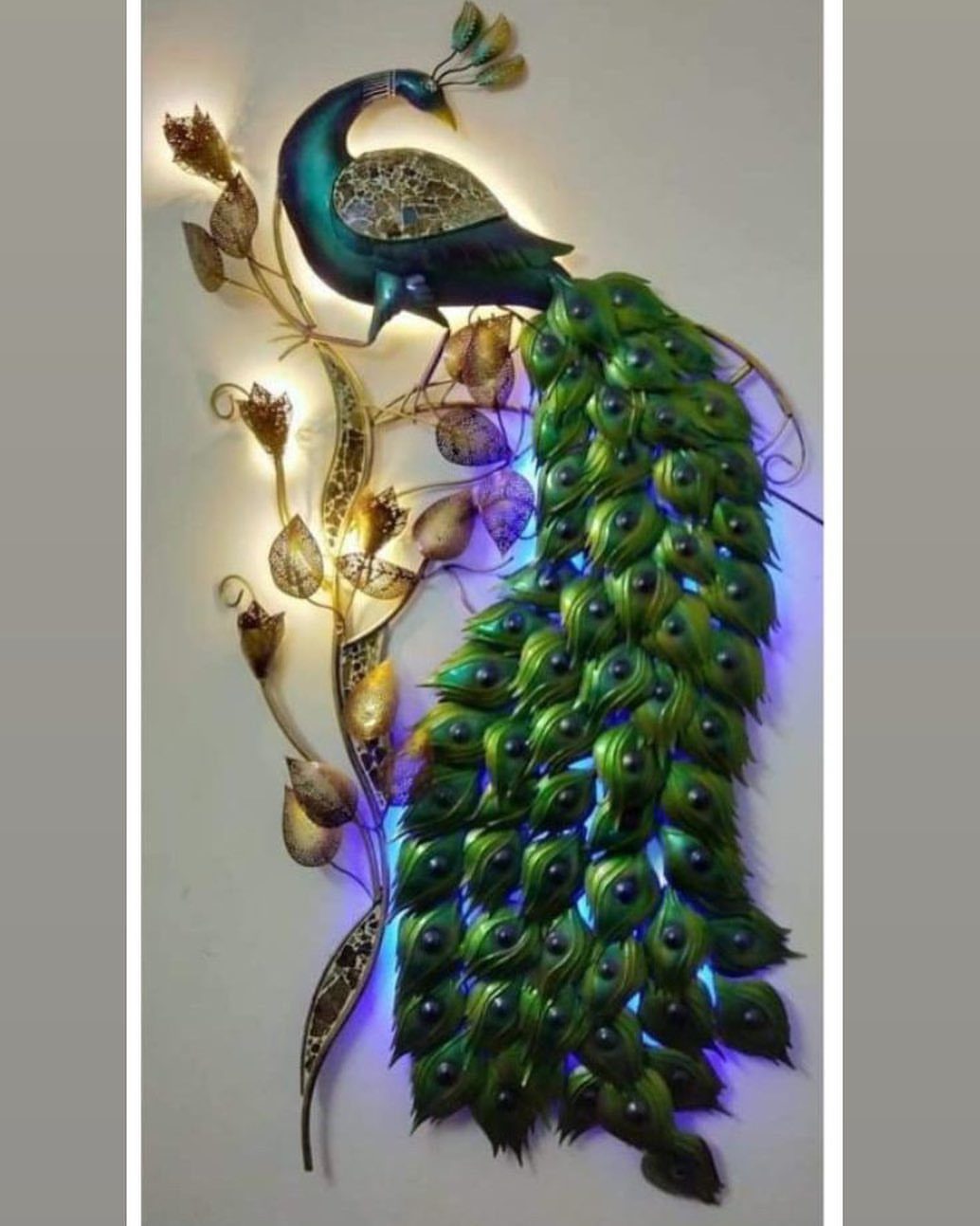 Indian Room Decor: 37 Ideas From Textiles to Wall Hangings 27 Peacock relief art with a blue body and green tail on a white wall.