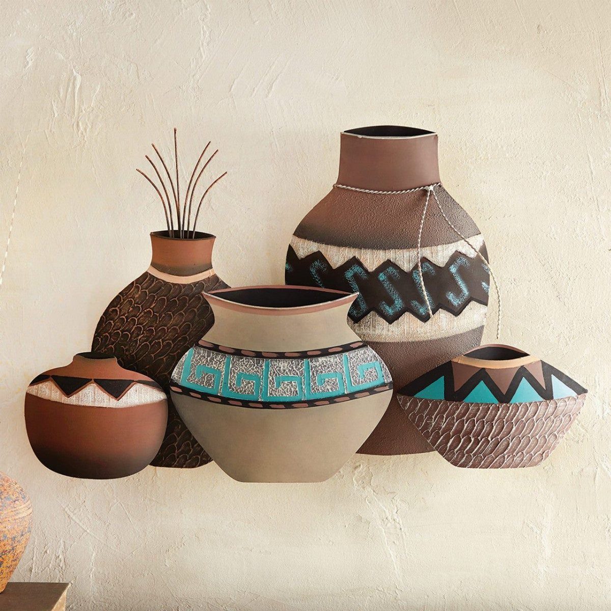 Indian Room Decor: 37 Ideas From Textiles to Wall Hangings 28 Sculptural pottery vases with geometric patterns mounted on a textured neutral wall.