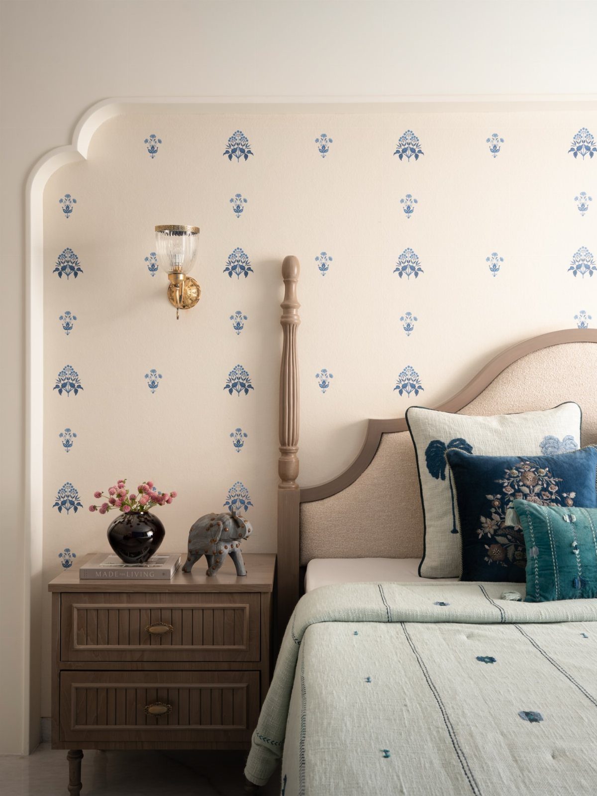 Indian Room Decor: 37 Ideas From Textiles to Wall Hangings 13 Bedroom with blue patterned bedding, wooden nightstand, and floral wallpaper with brass lamp.
