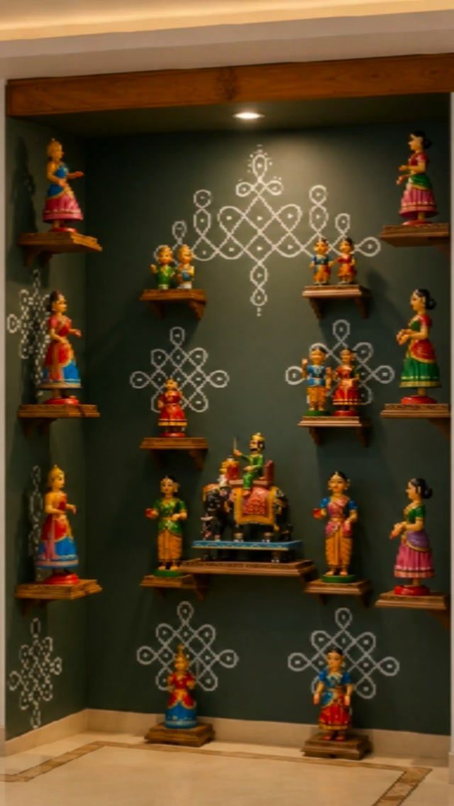 Indian Room Decor: 37 Ideas From Textiles to Wall Hangings 21 Wooden floating shelves on a green wall displaying colorful traditional Indian figurines.