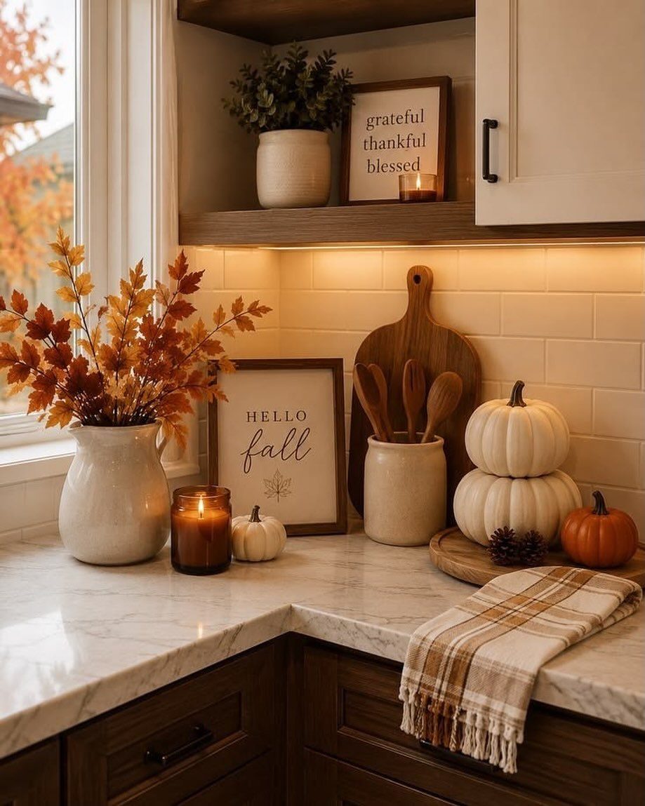 14 Kitchen Tabletop Decor Ideas to Style Your Counters 11 Autumnal kitchen counter display with pumpkins, orange leaves, and a fall themed sign.