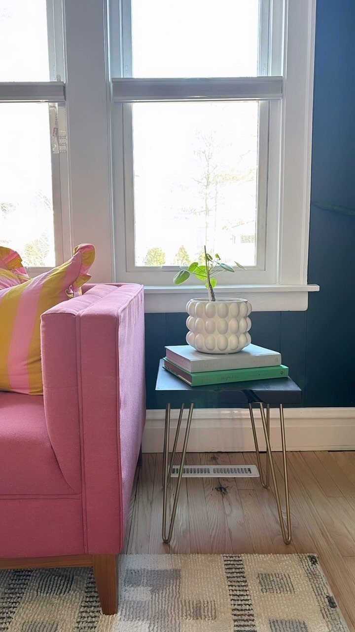 Mid Century Modern Items: 12 Ideas for Your Home 9 Black side table with metal hairpin legs holding books and a small plant.