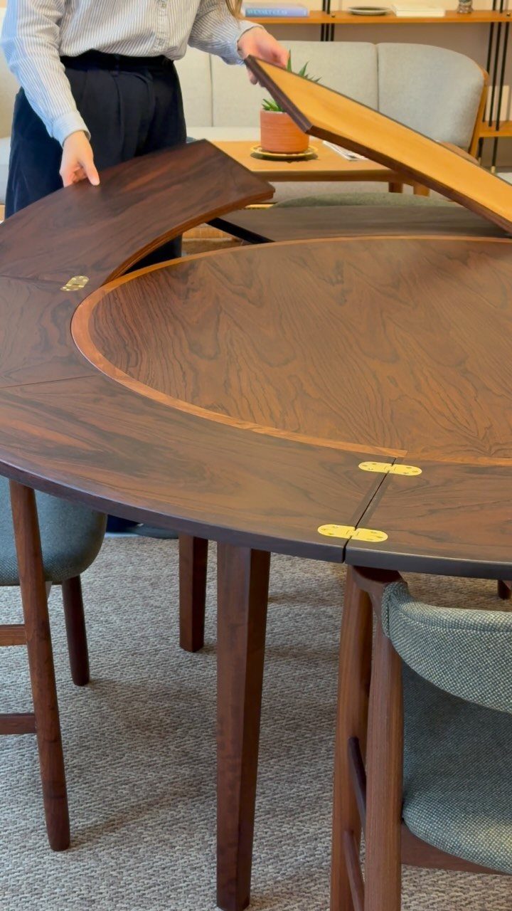 Mid Century Modern Items: 12 Ideas for Your Home 5 Round walnut mid-century modern dining table with an expandable leaf being lifted.