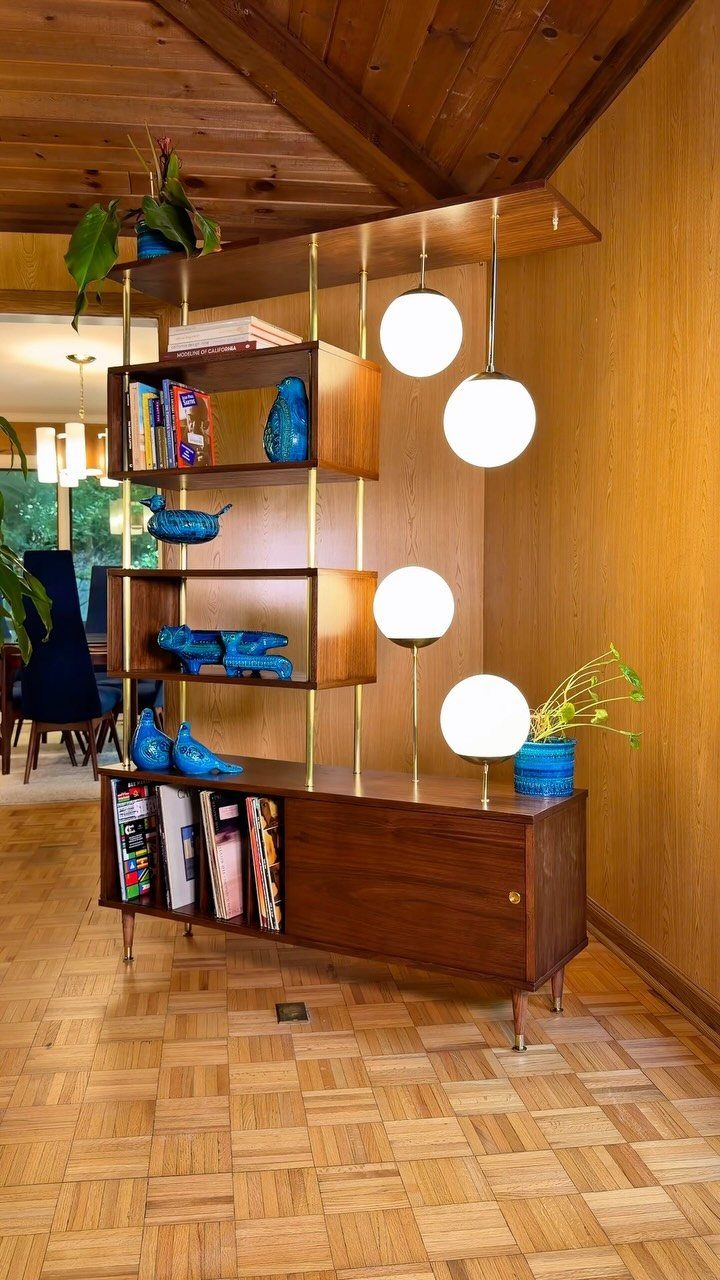 Mid Century Modern Items: 12 Ideas for Your Home 12 Mid-century modern wood and metal shelving unit with integrated white globe lighting.