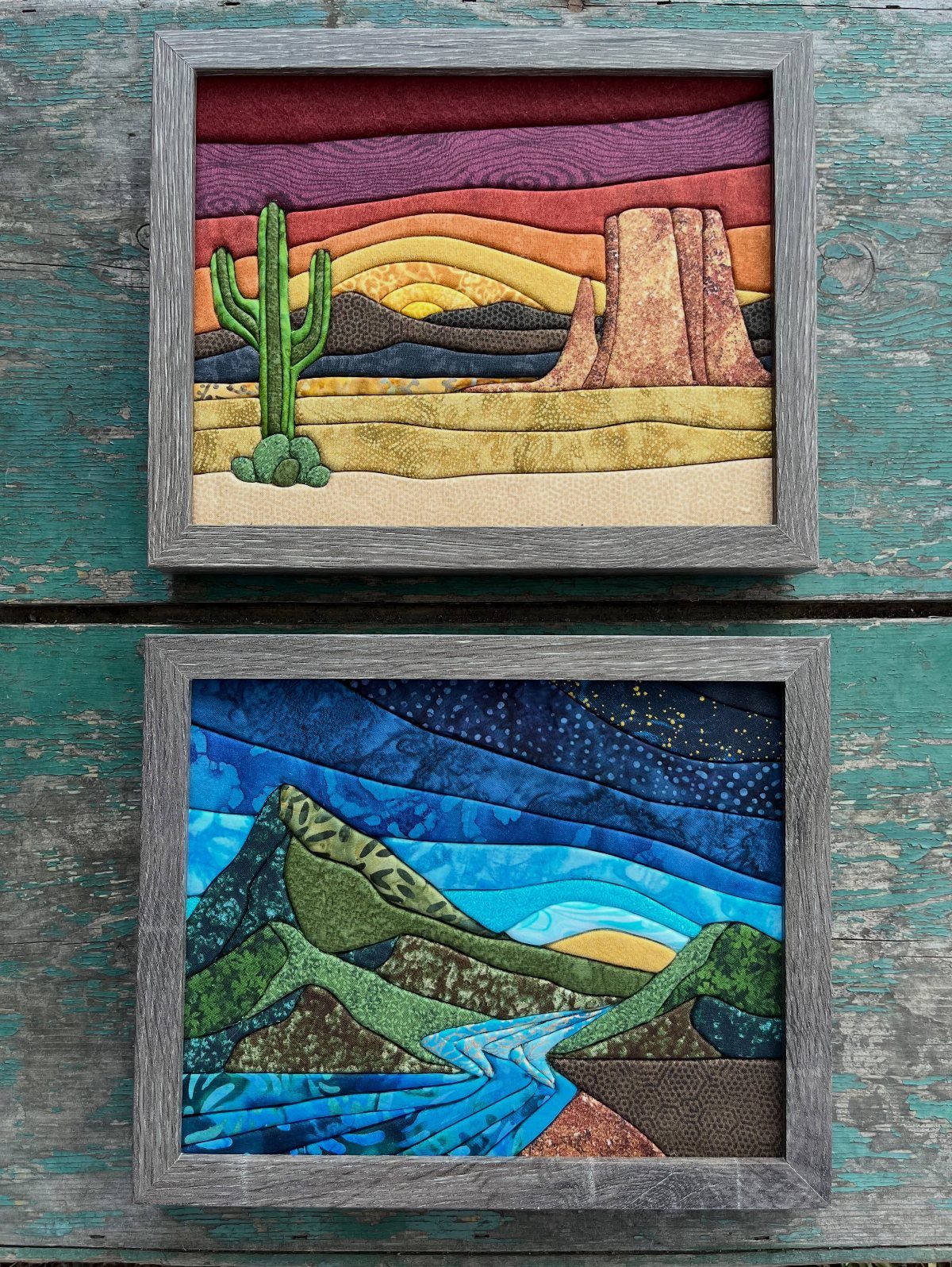 12 Modern Farmhouse Wall Decor Ideas for Living Room 3 Two framed fabric landscape art pieces hanging on a teal wooden wall.