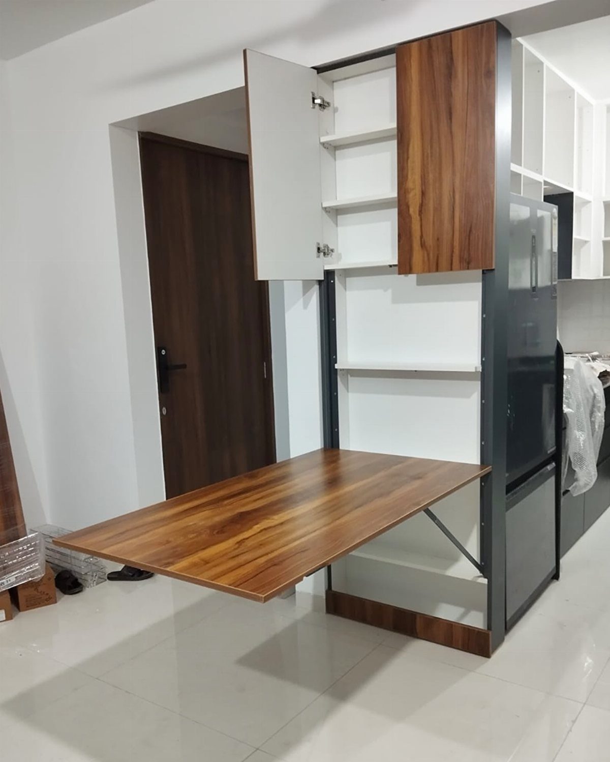 5 Modular Kitchen Table Designs for Flexible Dining Areas 2 Wooden folding table extended from a grey modular kitchen cabinet in a modern room.