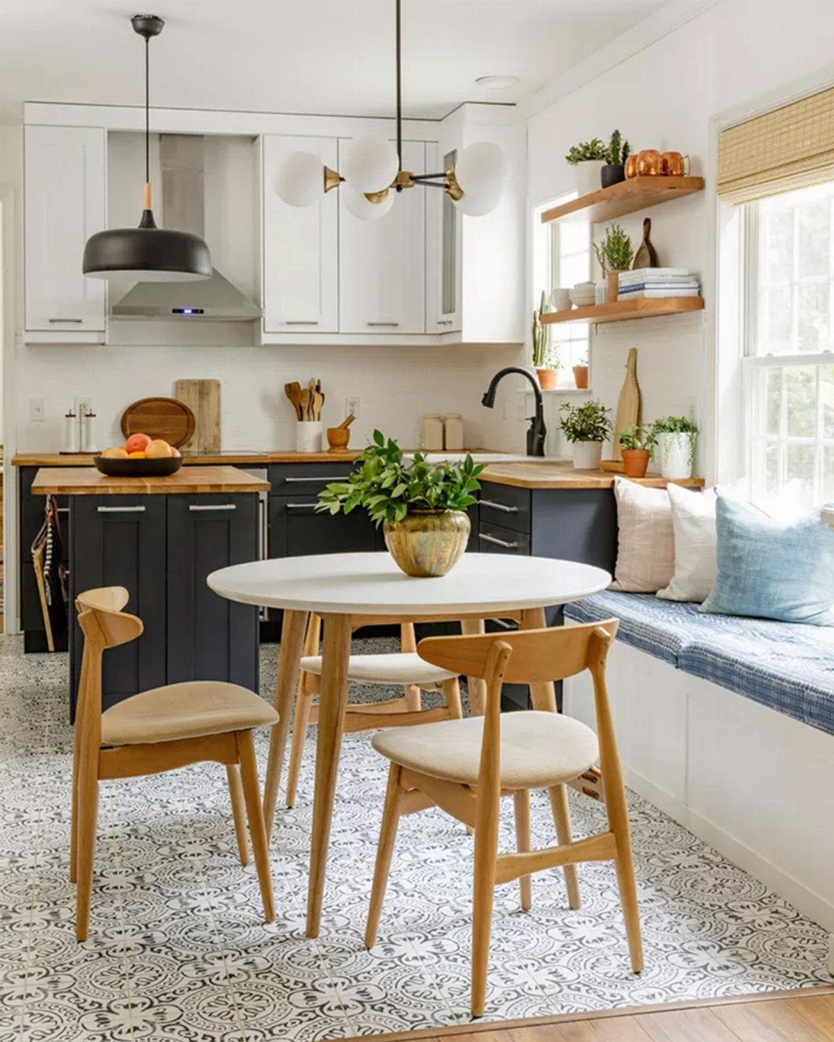 5 Modular Kitchen Table Designs for Flexible Dining Areas 6 Small round white dining table with wooden chairs in a bright kitchen setting.