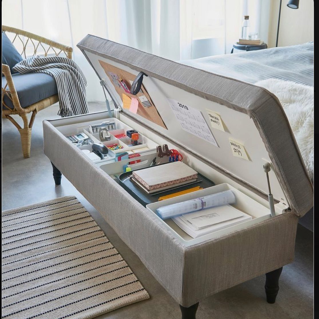 Grey fabric storage bench with open lid revealing organized interior compartments and documents.