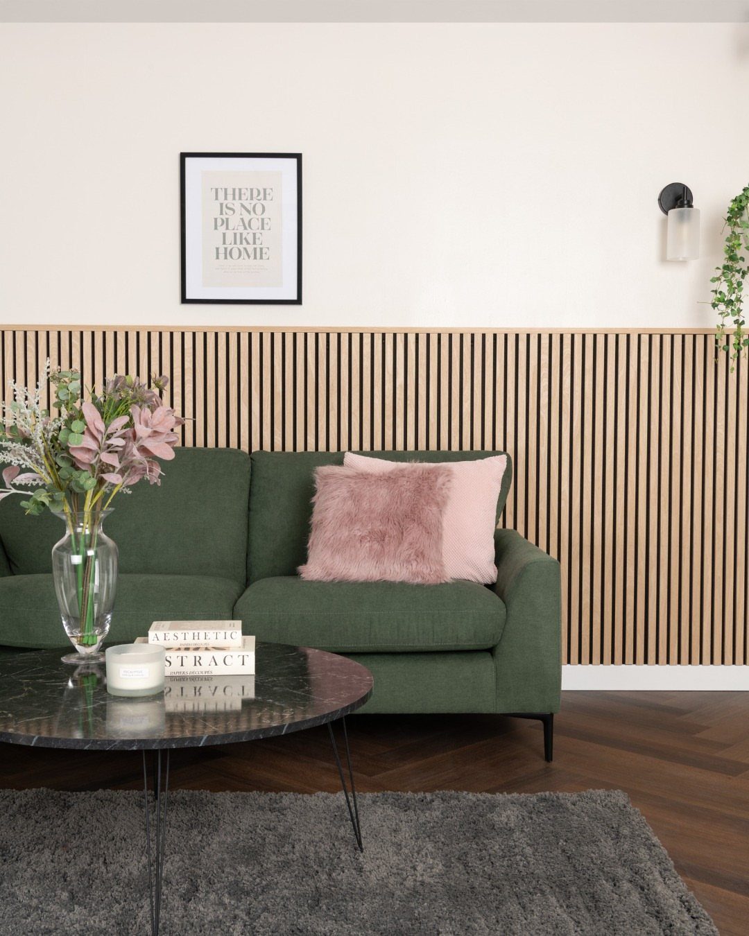 Oak Living Room Ideas: 9 Looks for Floors, Beams, Trim 7 Green sofa against a light oak wood slat wainscoting wall in a living room.