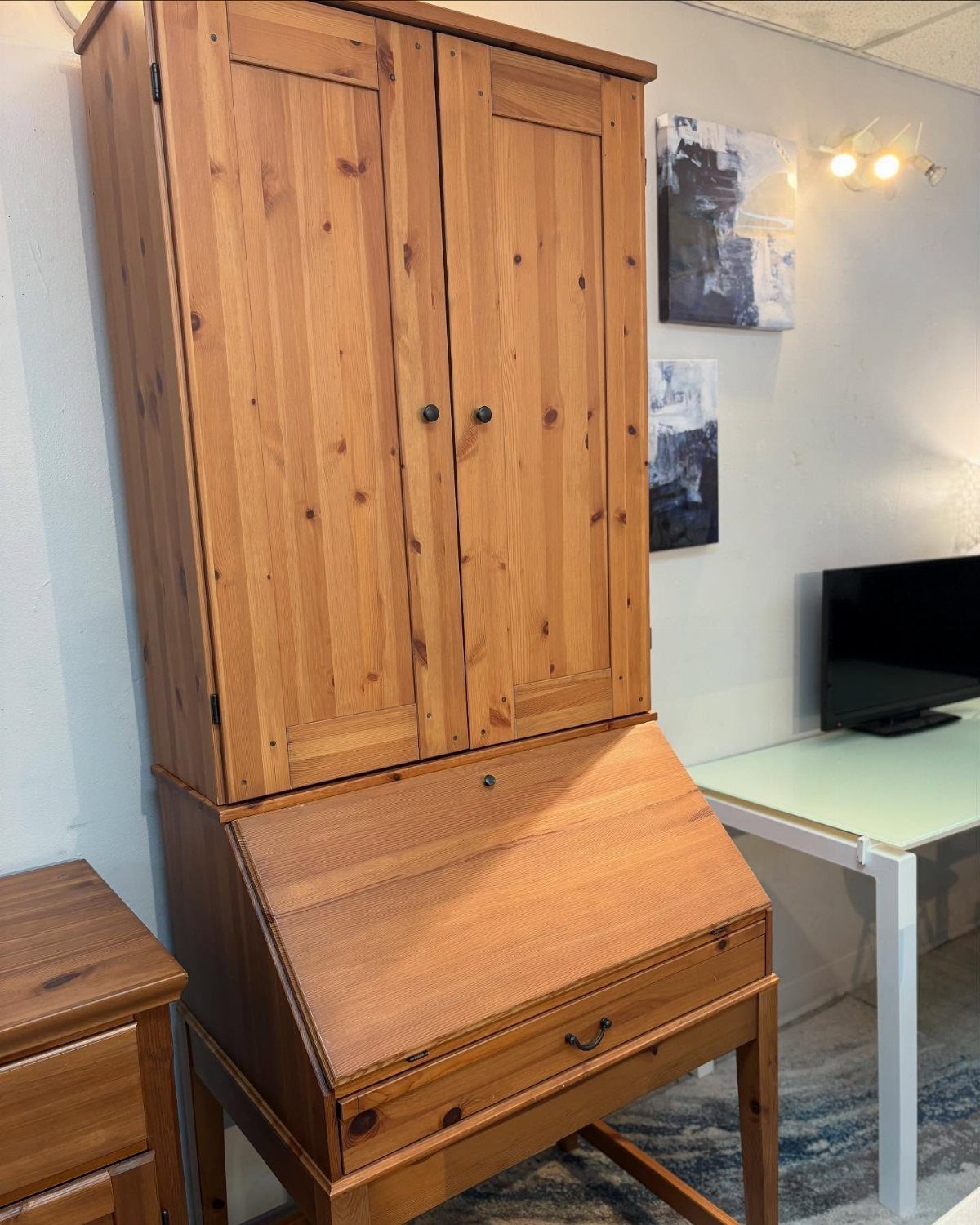 Wooden secretary desk with a slant-front and a tall upper hutch cabinet.