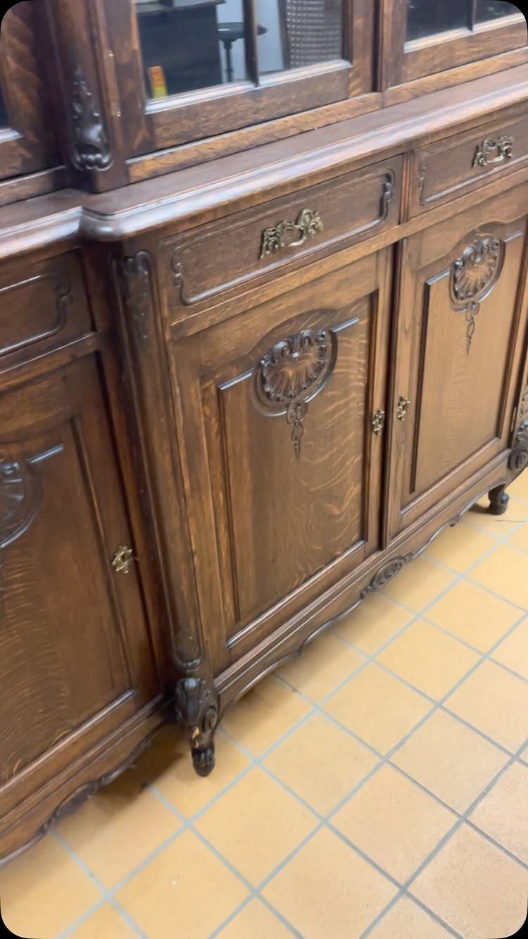 Ornate dark wood French vaisselier hutch with carved doors and glass upper cabinets.