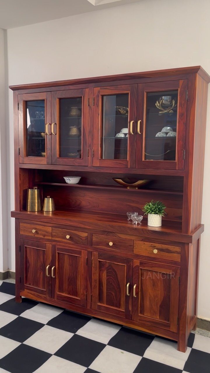 Reddish-brown natural wood hutch with glass cabinets and drawers on checkered flooring.