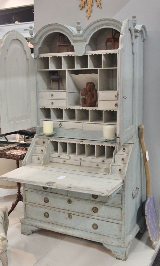 Oyster white Swedish secretary hutch with drop-down desk and small storage compartments.