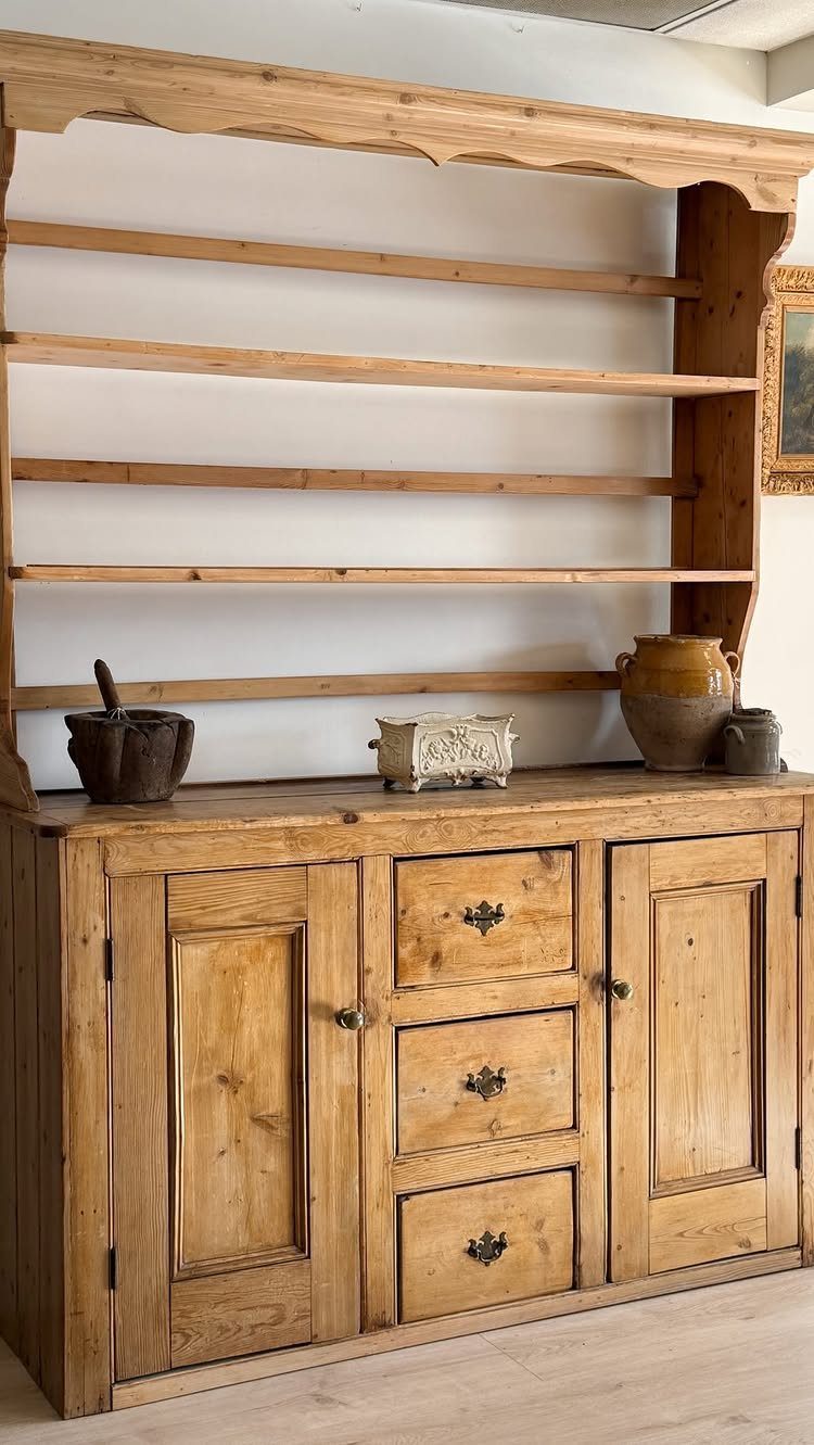 Light wood pine hutch with open shelving and lower storage cabinets and drawers.