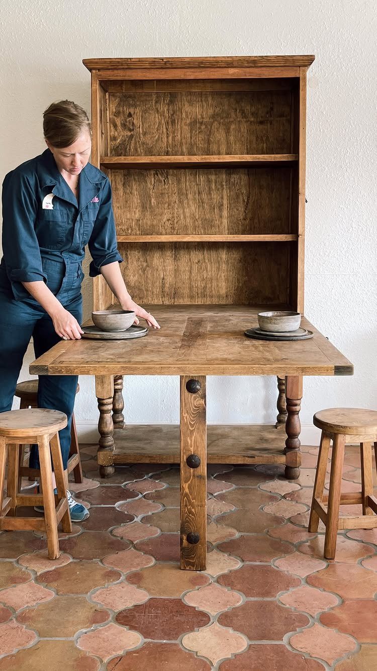 Rustic reclaimed barnwood hutch with open shelving and a large wooden table base.
