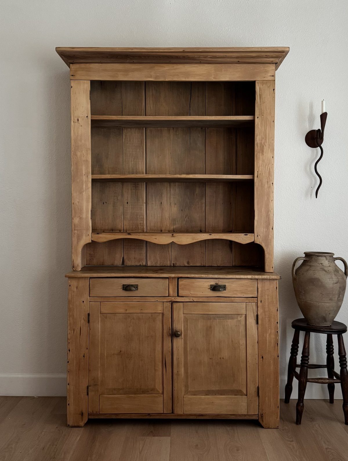 Rustic wood hutch with a decorative scalloped trim edge on the bottom shelf.