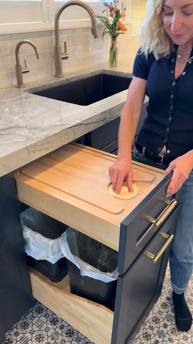 Pull Out Counter Ideas: 8 Ways to Add Kitchen Work Space 7 Wooden chopping board covering a pull-out drawer with trash bins in a kitchen.