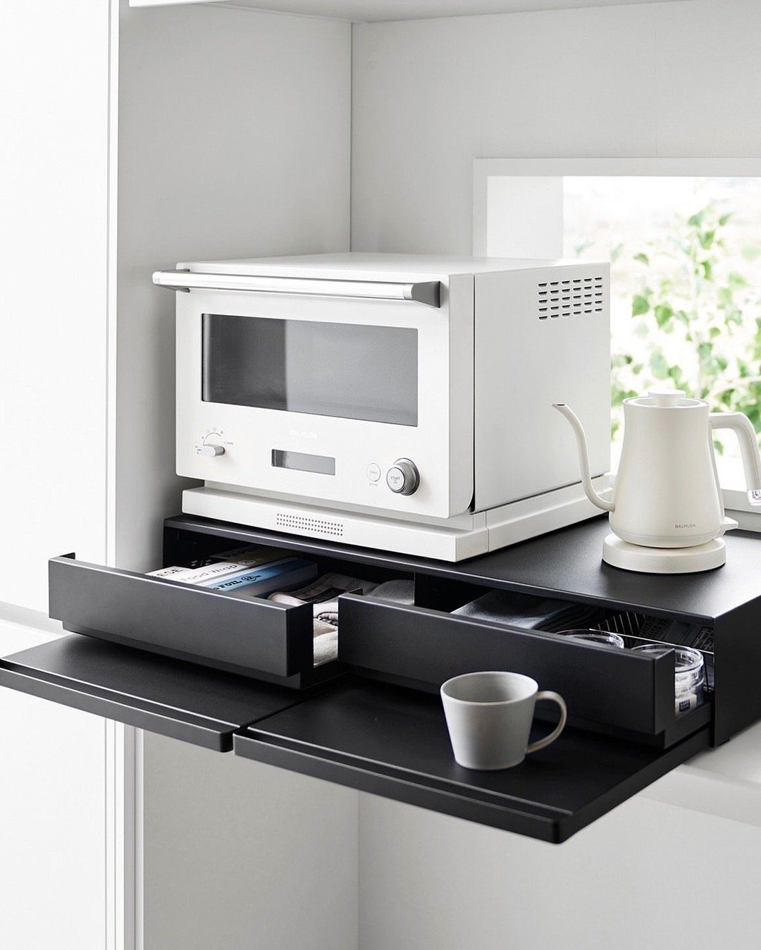 Pull Out Counter Ideas: 8 Ways to Add Kitchen Work Space 3 Black metal pull-out tray organizer under a white microwave with a grey mug.